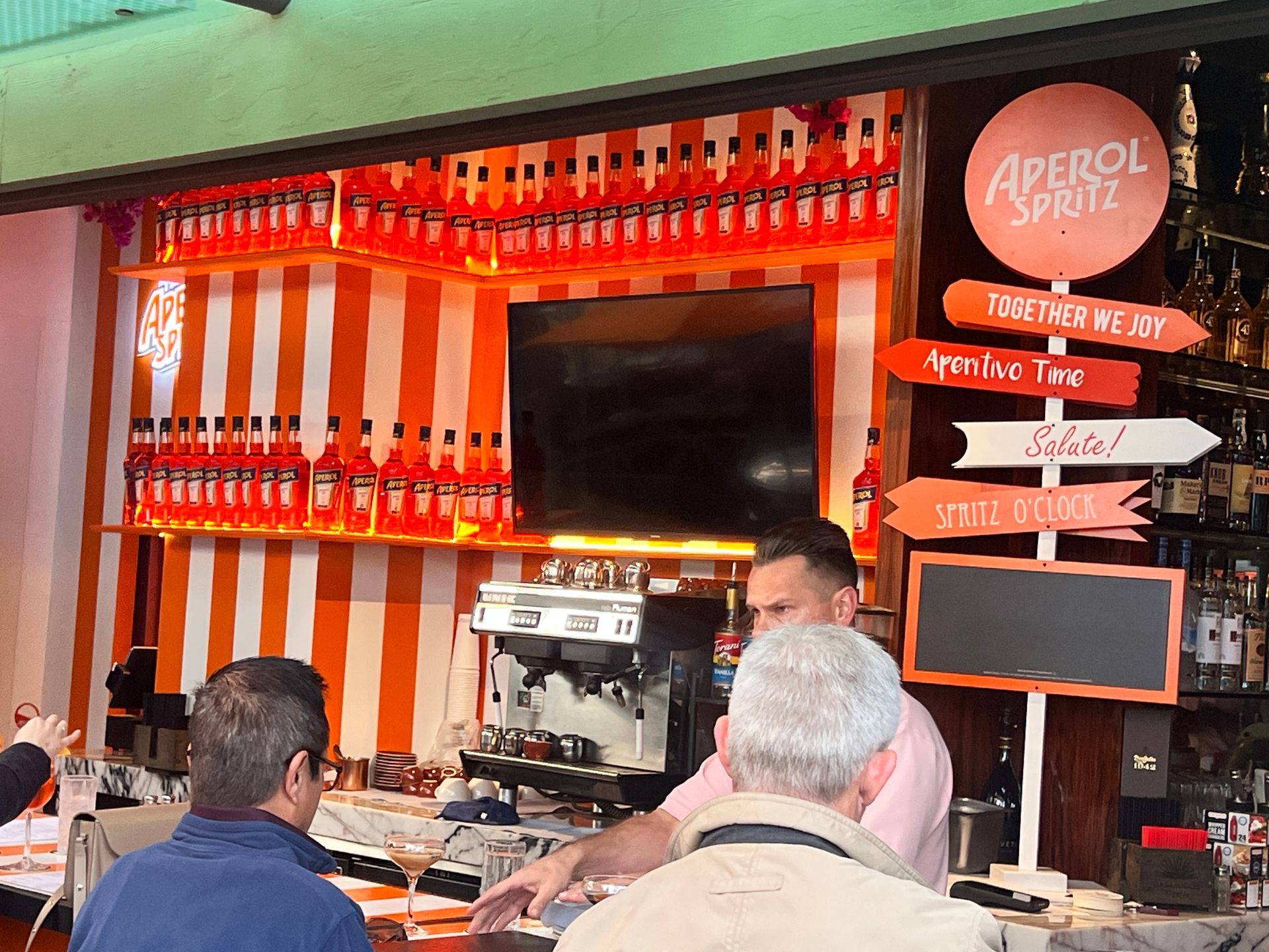 A bar with a sign that says aperol spritz on it