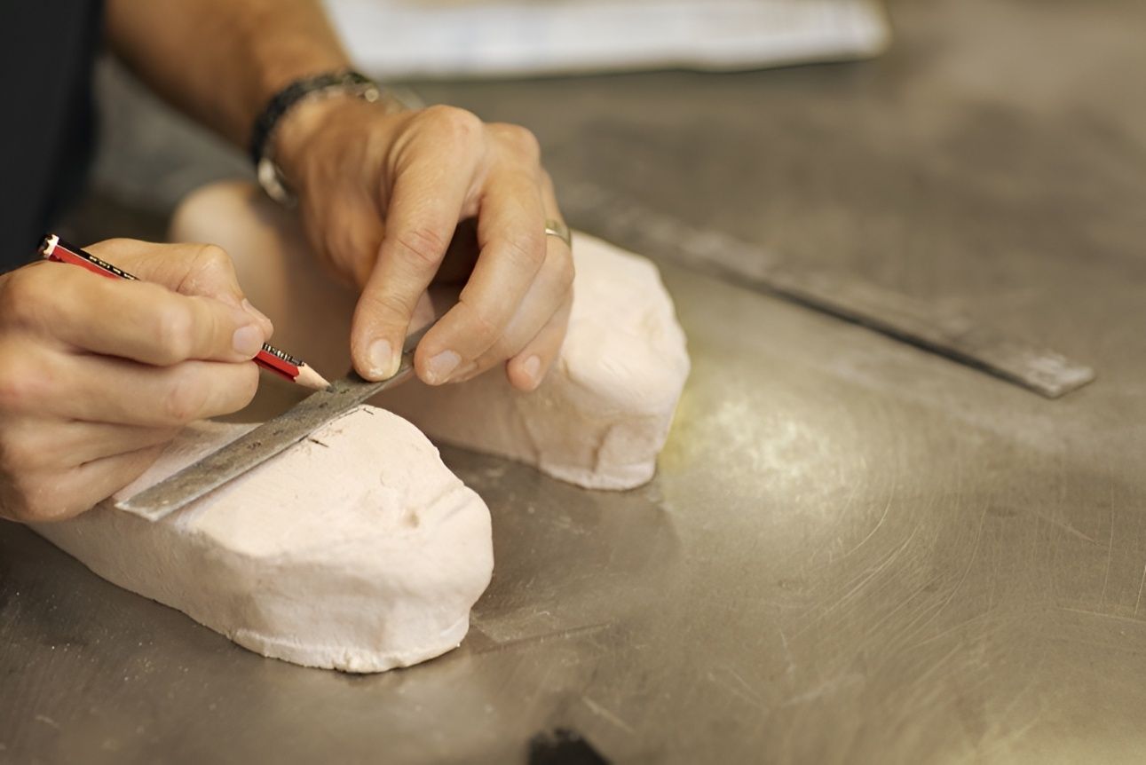 A Person is Measuring a Piece of Clay With a Ruler — Hastings Podiatry Centre In Port Macquarie, NSW