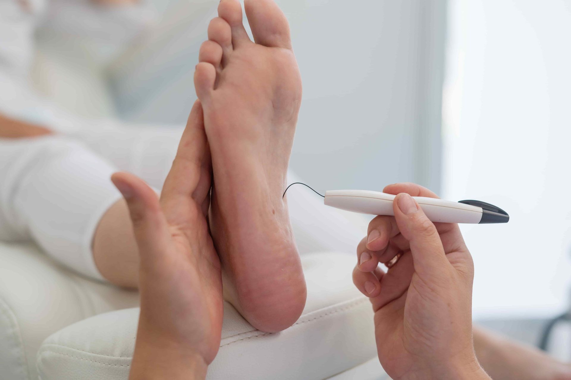 A Person Is Holding A Marker Over A Person's Foot — Hastings Podiatry Centre In Port Macquarie, NSW