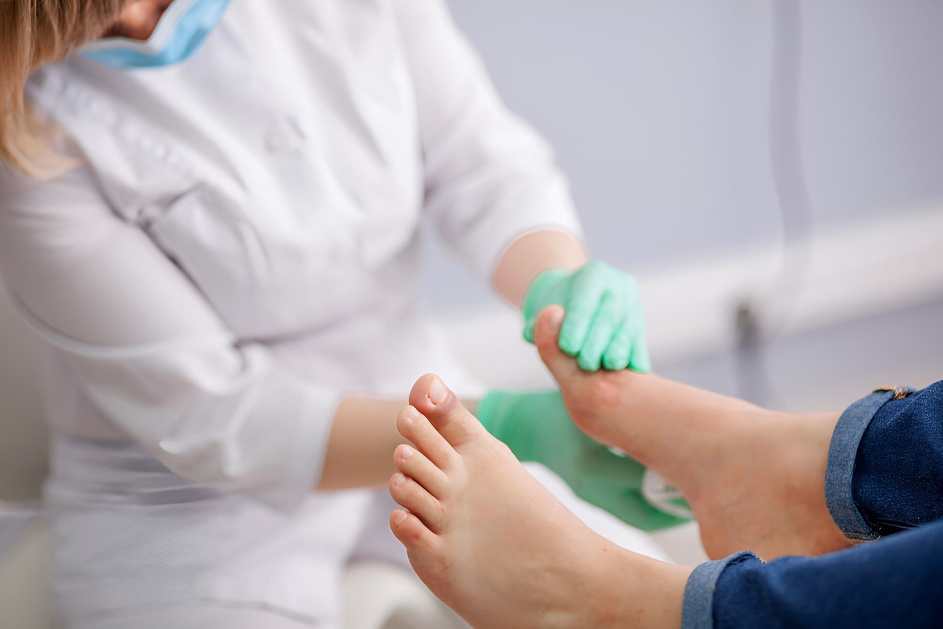 A Doctor Is Examining A Patient's Foot In A Hospital — Hastings Podiatry Centre In Port Macquarie, NSW