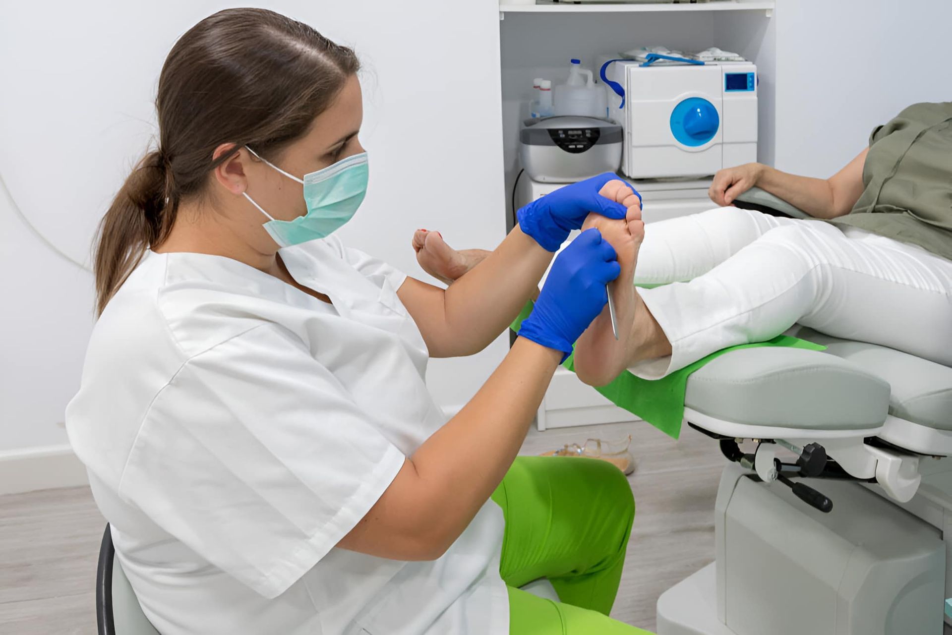 A Woman Is Giving A Foot Massage To A Patient — Hastings Podiatry Centre In Port Macquarie, NSW
