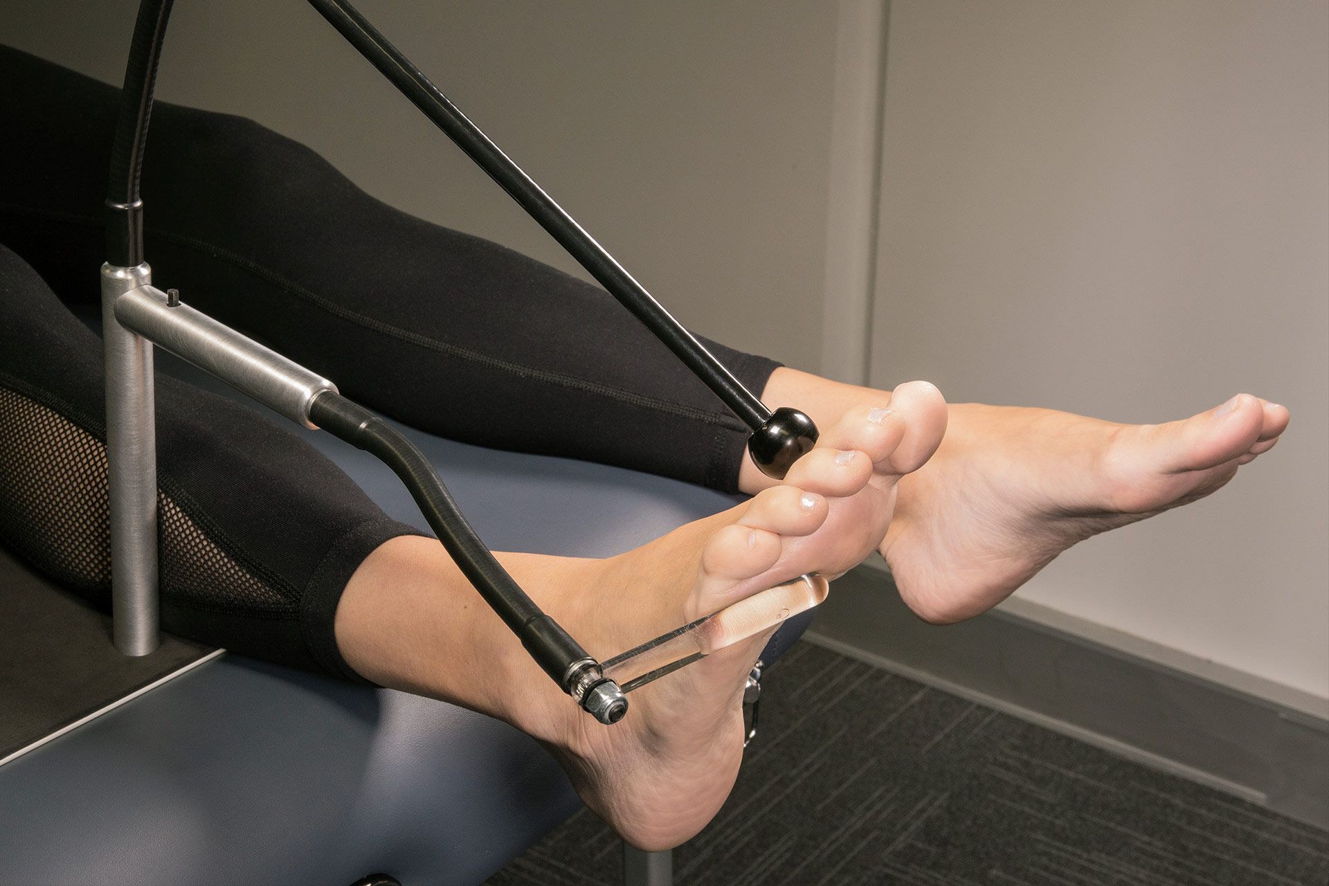 A Woman is Getting Her Feet Scanned — Hastings Podiatry Centre In Port Macquarie, NSW