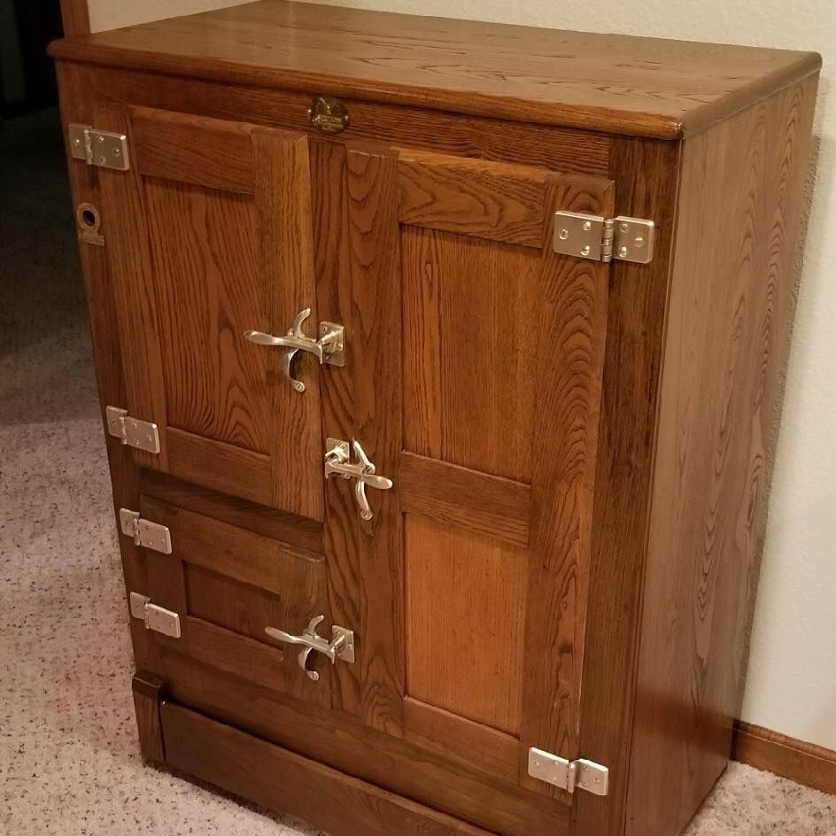 A wooden cabinet with two doors and two drawers