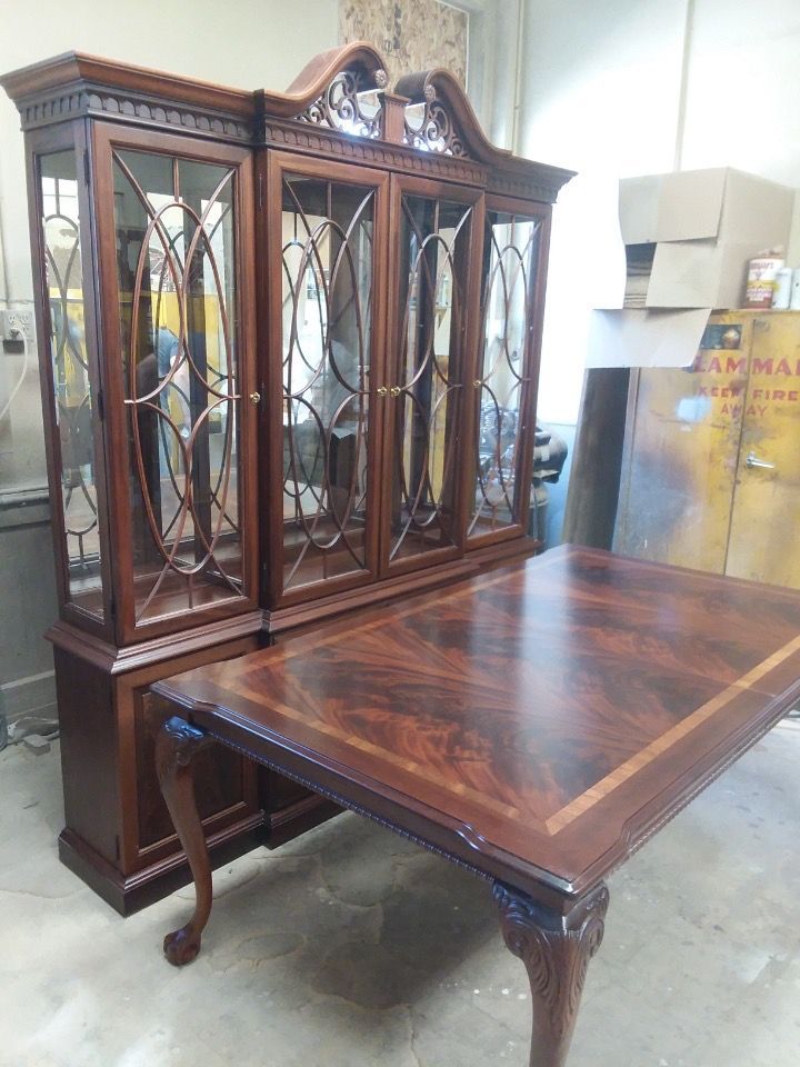 A large wooden table with a hutch in the background