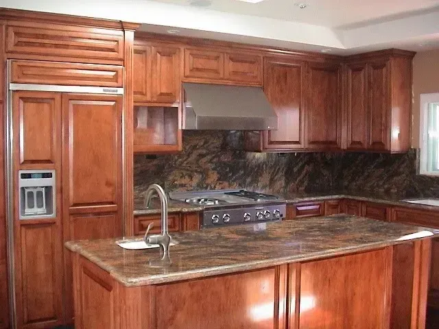 A kitchen with wooden cabinets and granite counter tops