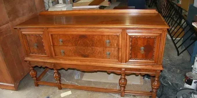 A wooden dresser with drawers and a mirror on top of it.