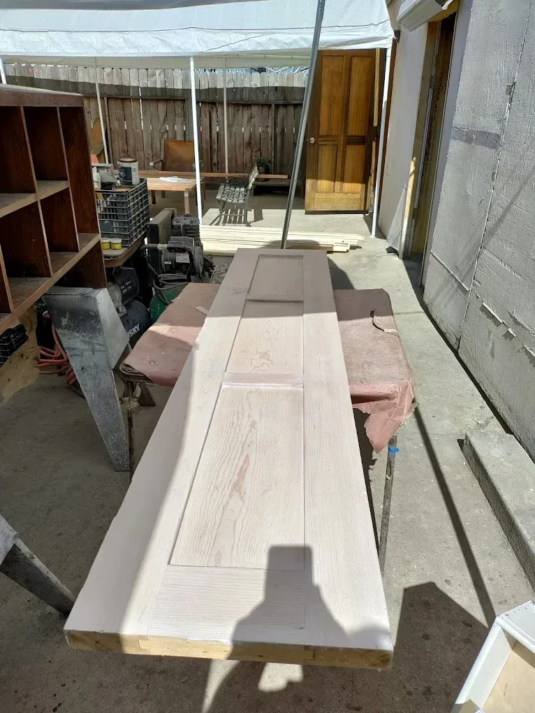 A long piece of wood is sitting on top of a table.
