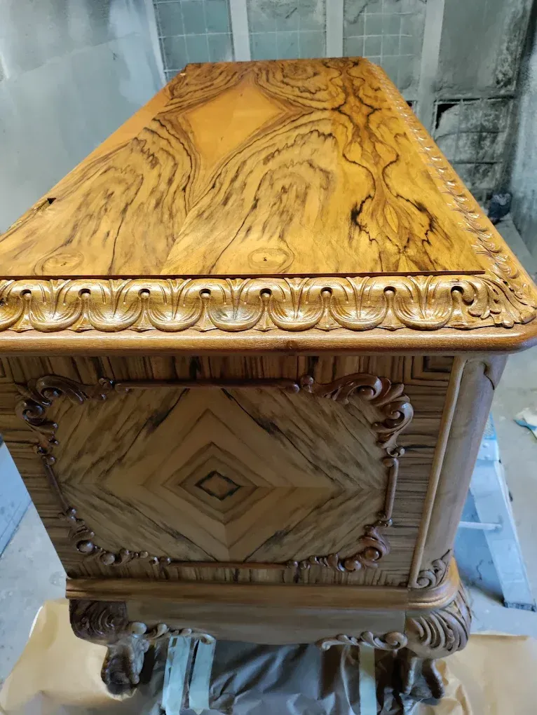 A wooden chest is sitting on top of a table.