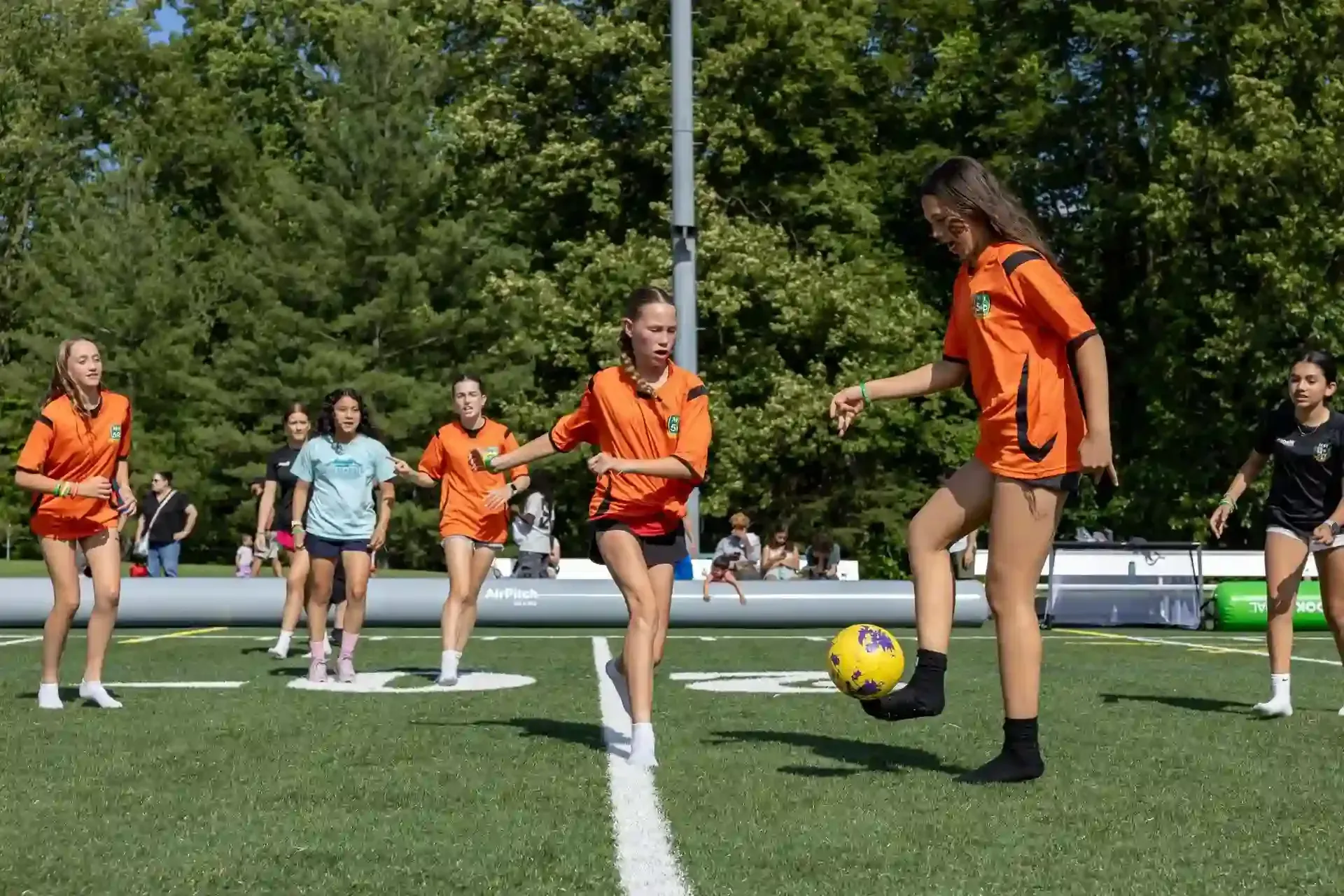 MSI Girls playing small-sided games in an inflatable field during Soccerfest 2025.