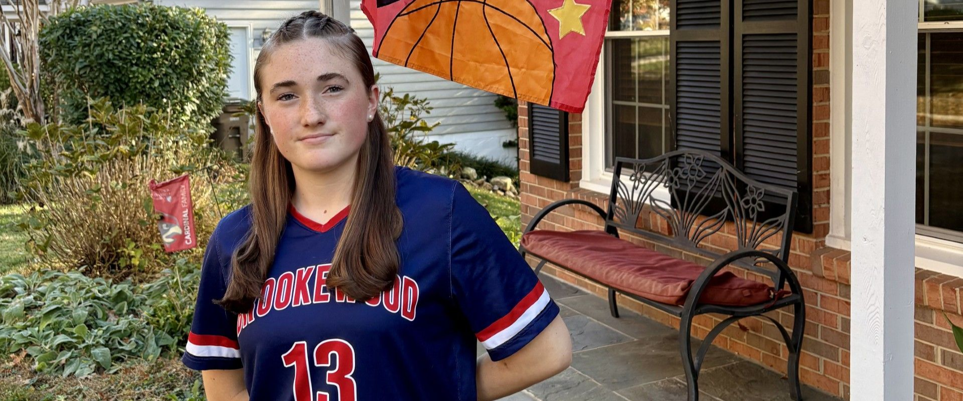 MSI player Juliana Combs standing in front of a house with her soccer jersey on.