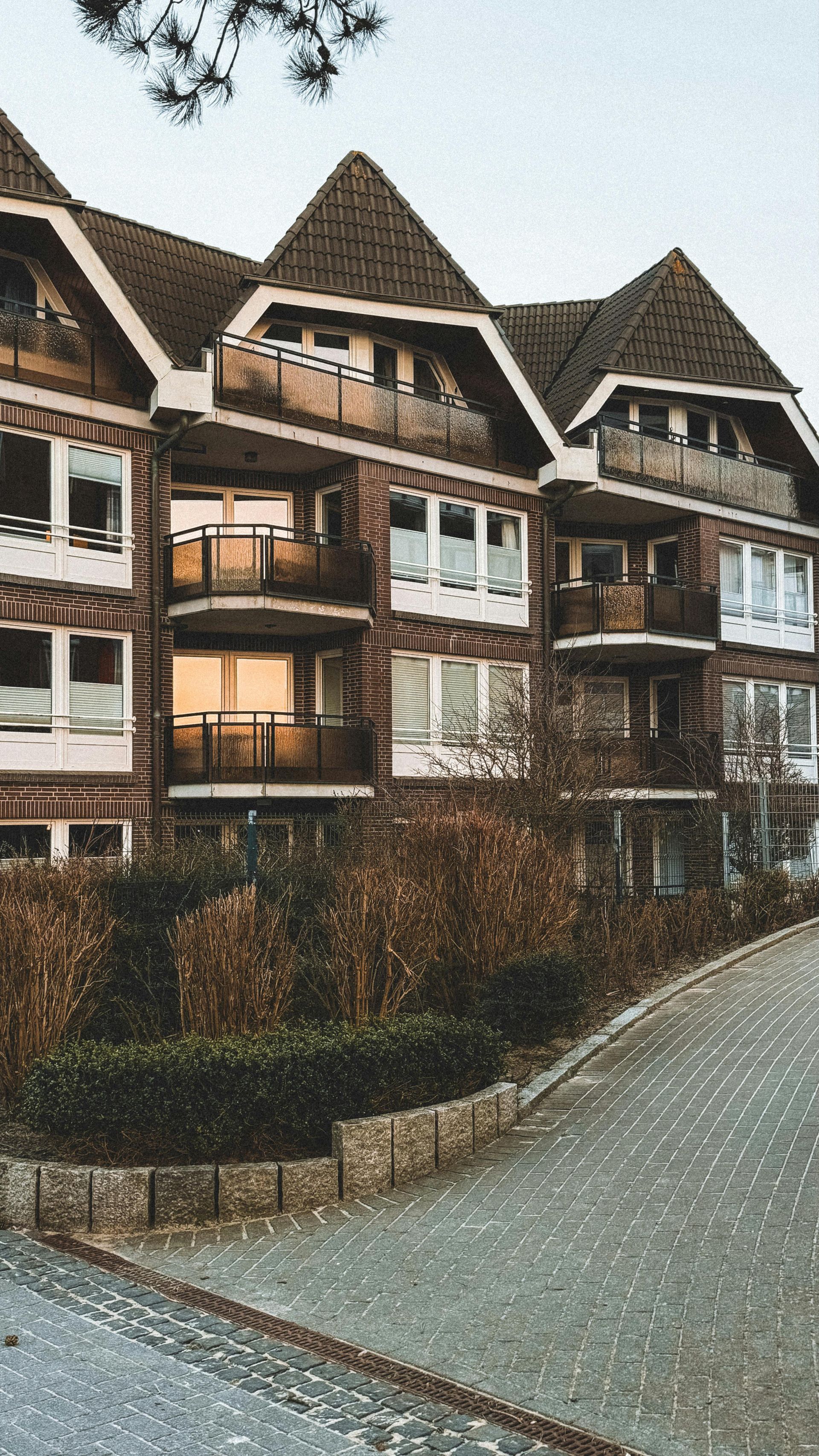 A yellow pipe is sitting on top of a black roof.