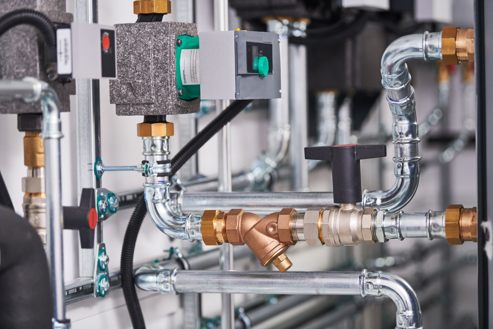 A bunch of pipes are connected to each other in a room.
