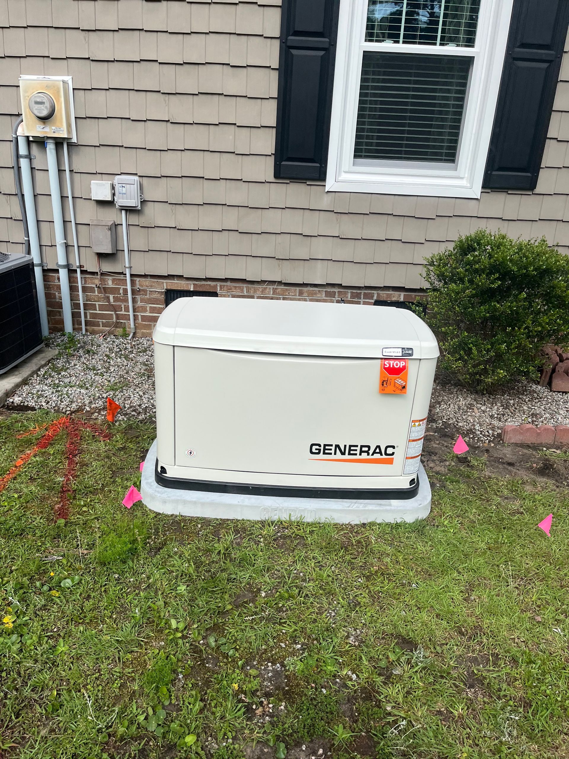 A person holding a baby up in the air indoors near a window, baby smiling.
