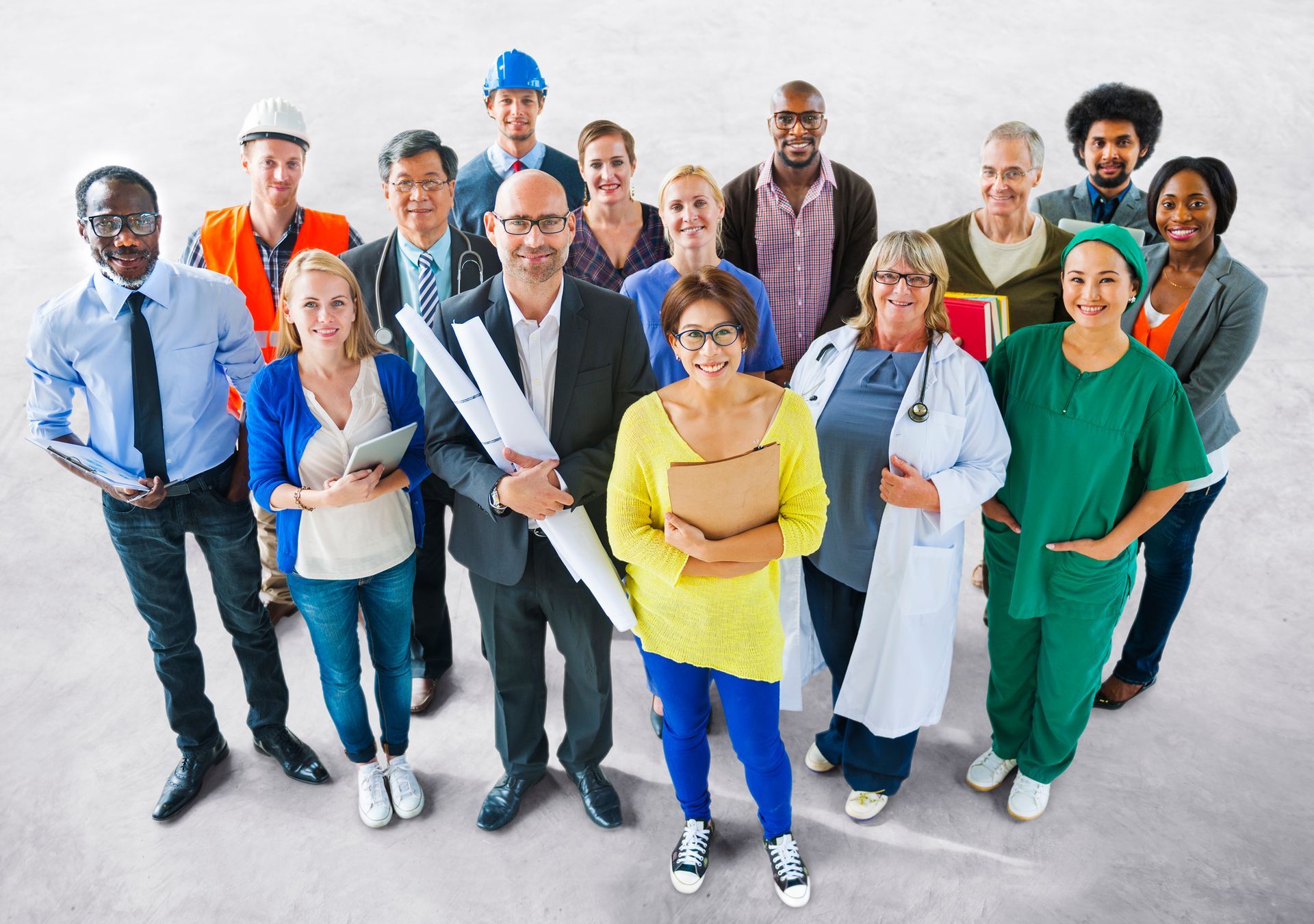 Group of diverse professionals smiling, looking up.