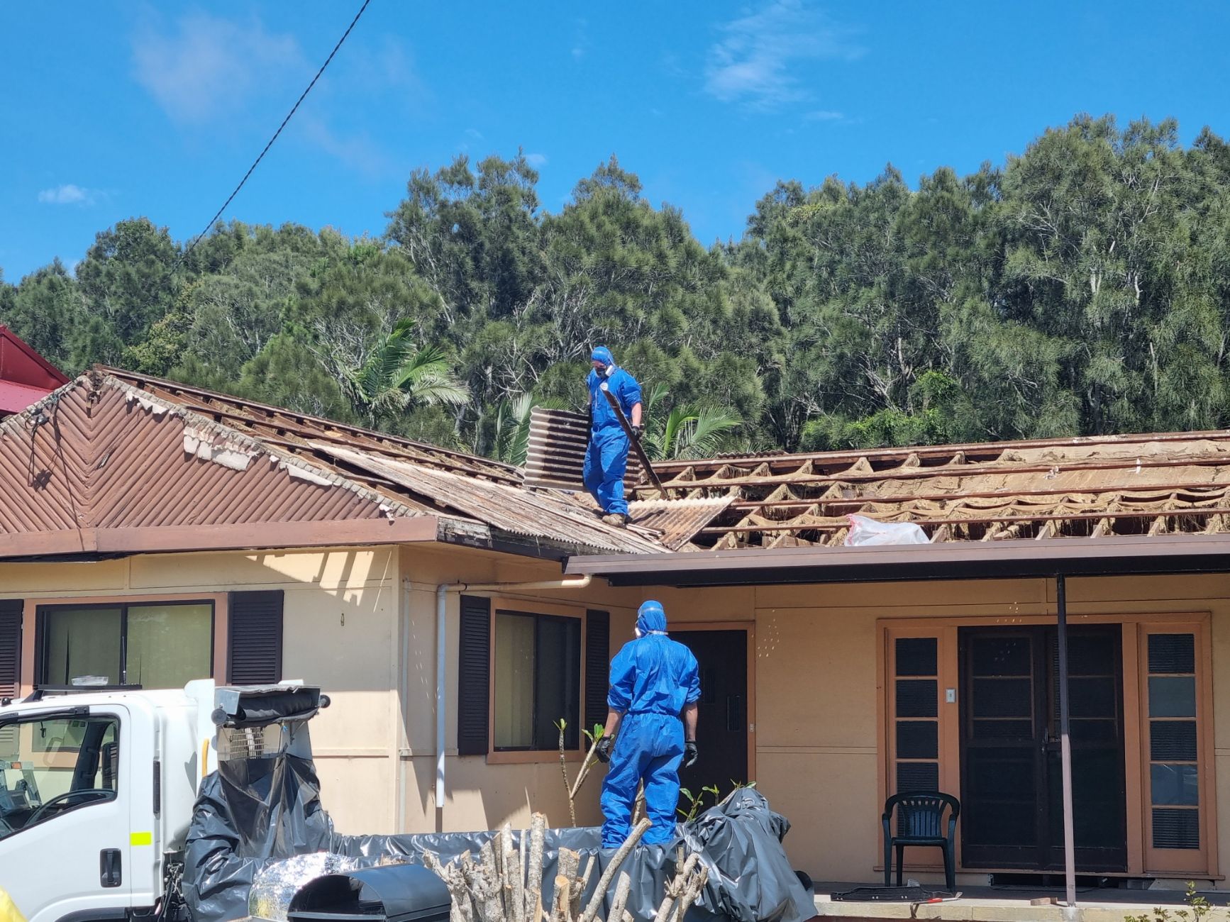 A man is working on the roof of a house.