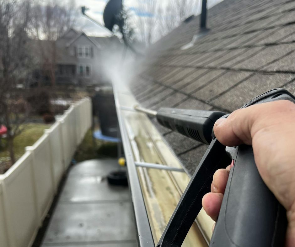 Professional cleaning of roof gutters to remove grime, dirt, and trapped debris.