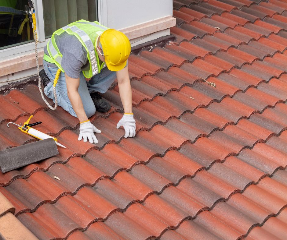 Professional roofer assessing roof tile condition