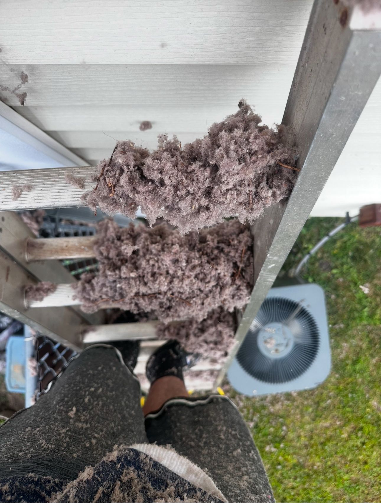 A ladder with dust from a dirty HVAC air duct vent on it.