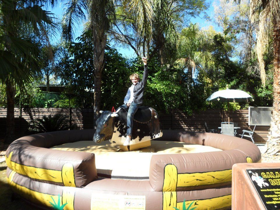 A person riding a mechanical bull