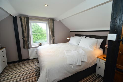 Large white bed by a window