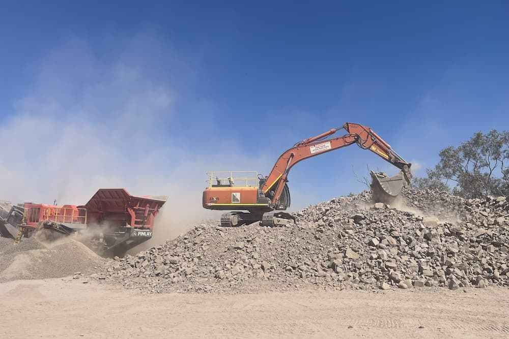 Excavator Moving Debris — Construction Supplies in Lansdowne, NT