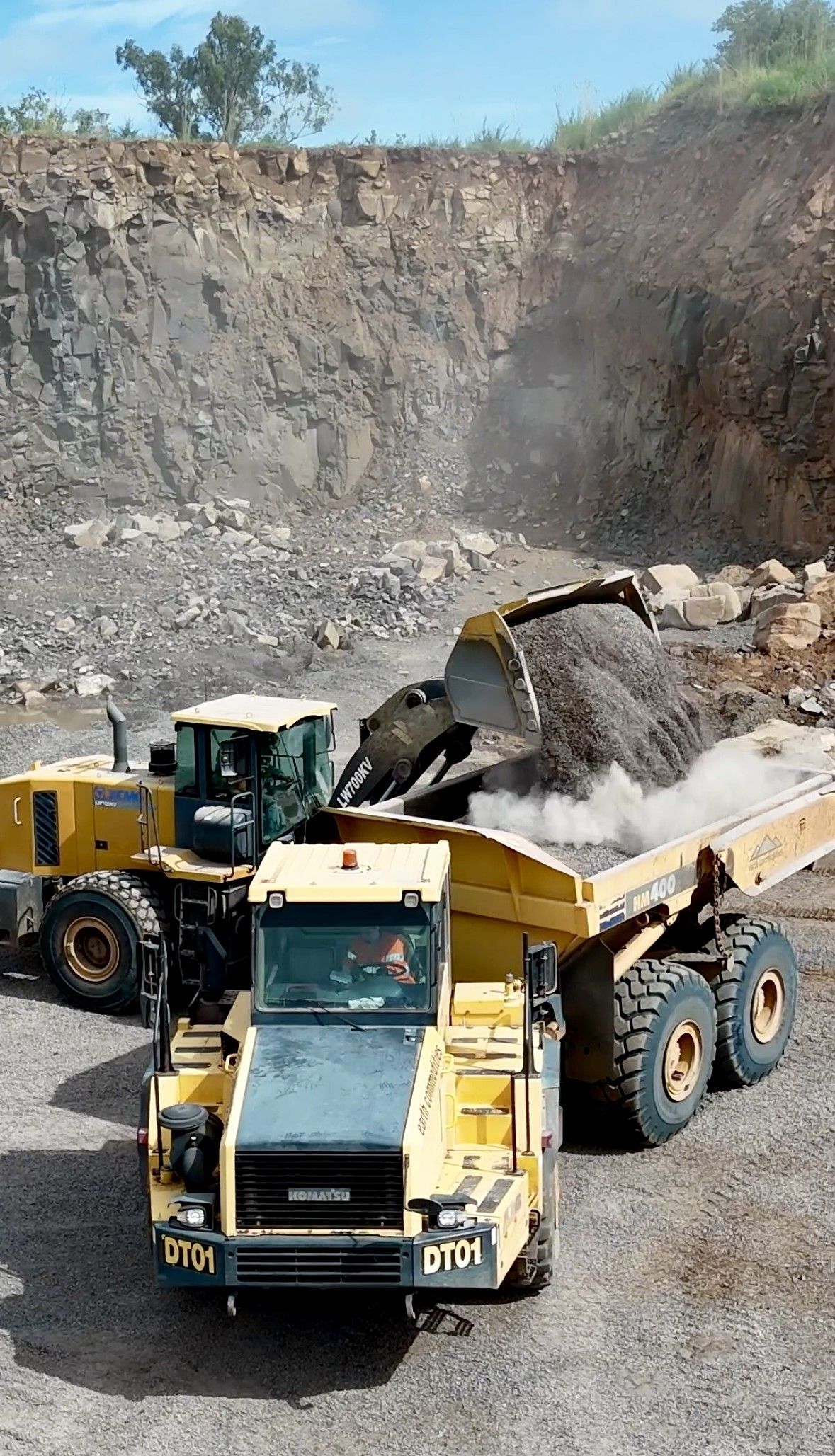 A Front-end Loader Filling a Dump Truck With Gravel in a Quarry — D&S Quarries in Lansdowne, NT