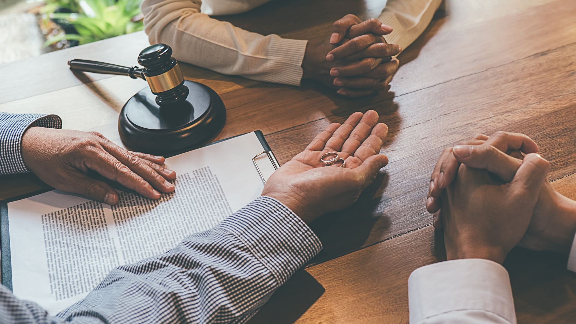 A married couple signs for divorce at a divorce attorney's office. A married couple signs for divorce at a divorce attorney's office.