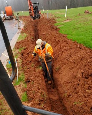 man in dirt trench