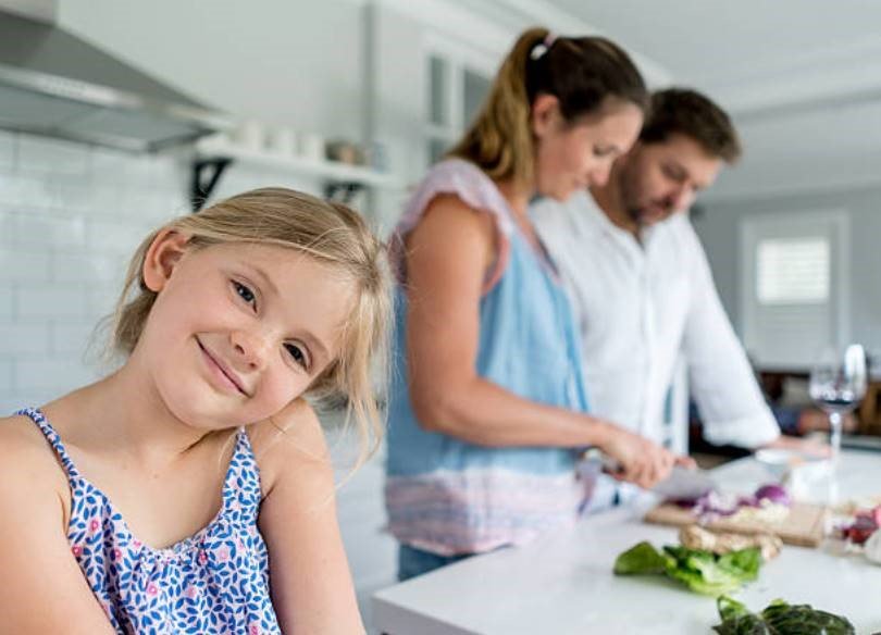 A family enjoying a kitchen designed by cabinet makers in Adelaide