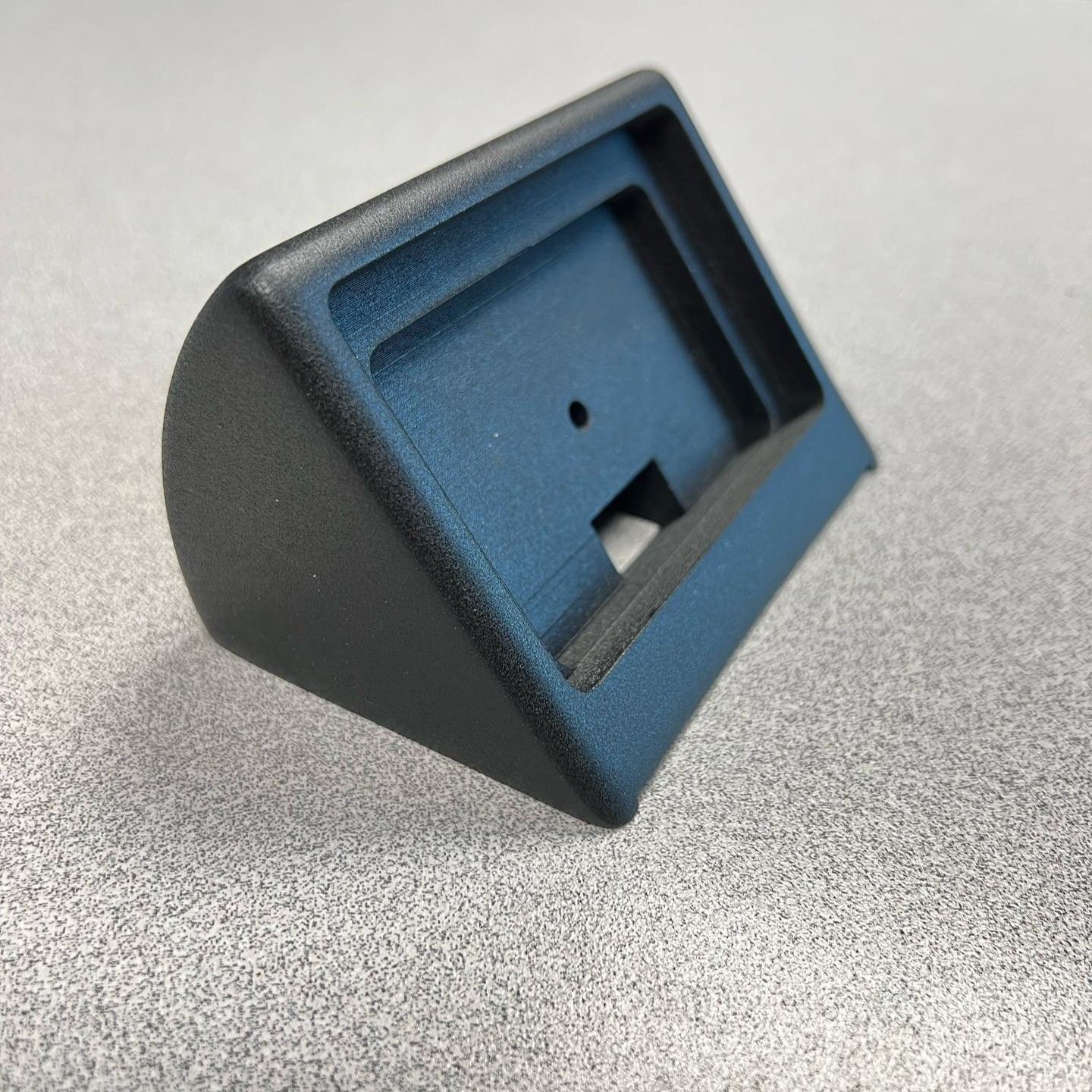 A black plastic item with a hole in the middle