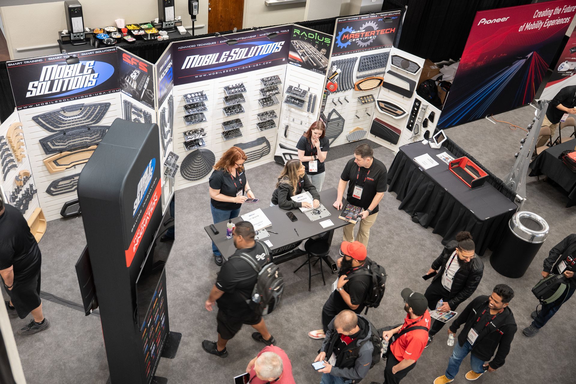 Trade show booth with people viewing product displays and interacting with staff.