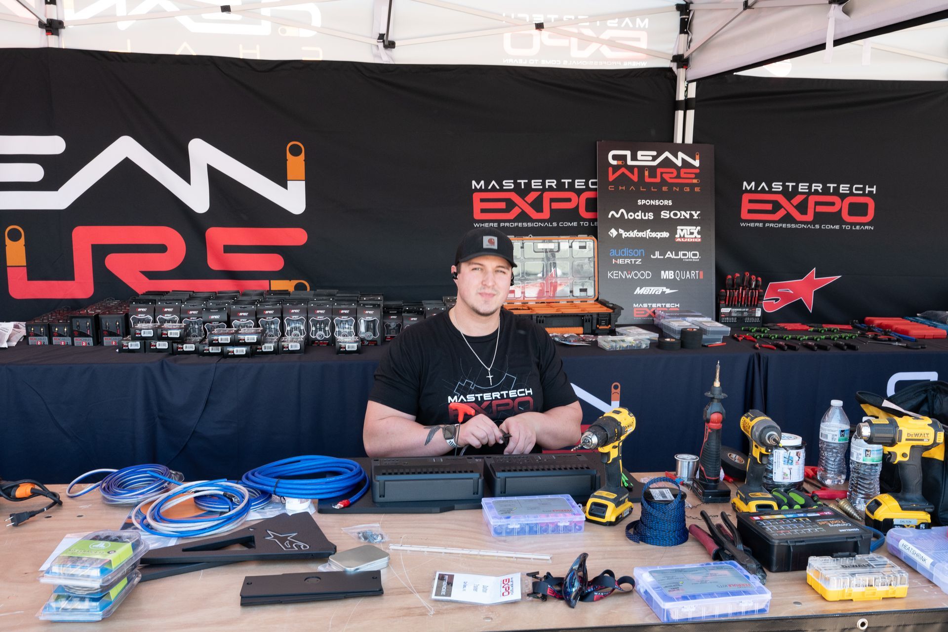 Man at a booth with tools and displays at the 