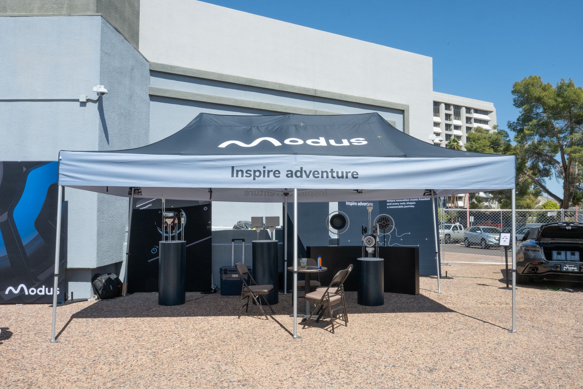 Modus booth at an outdoor event, gray tent, logo 