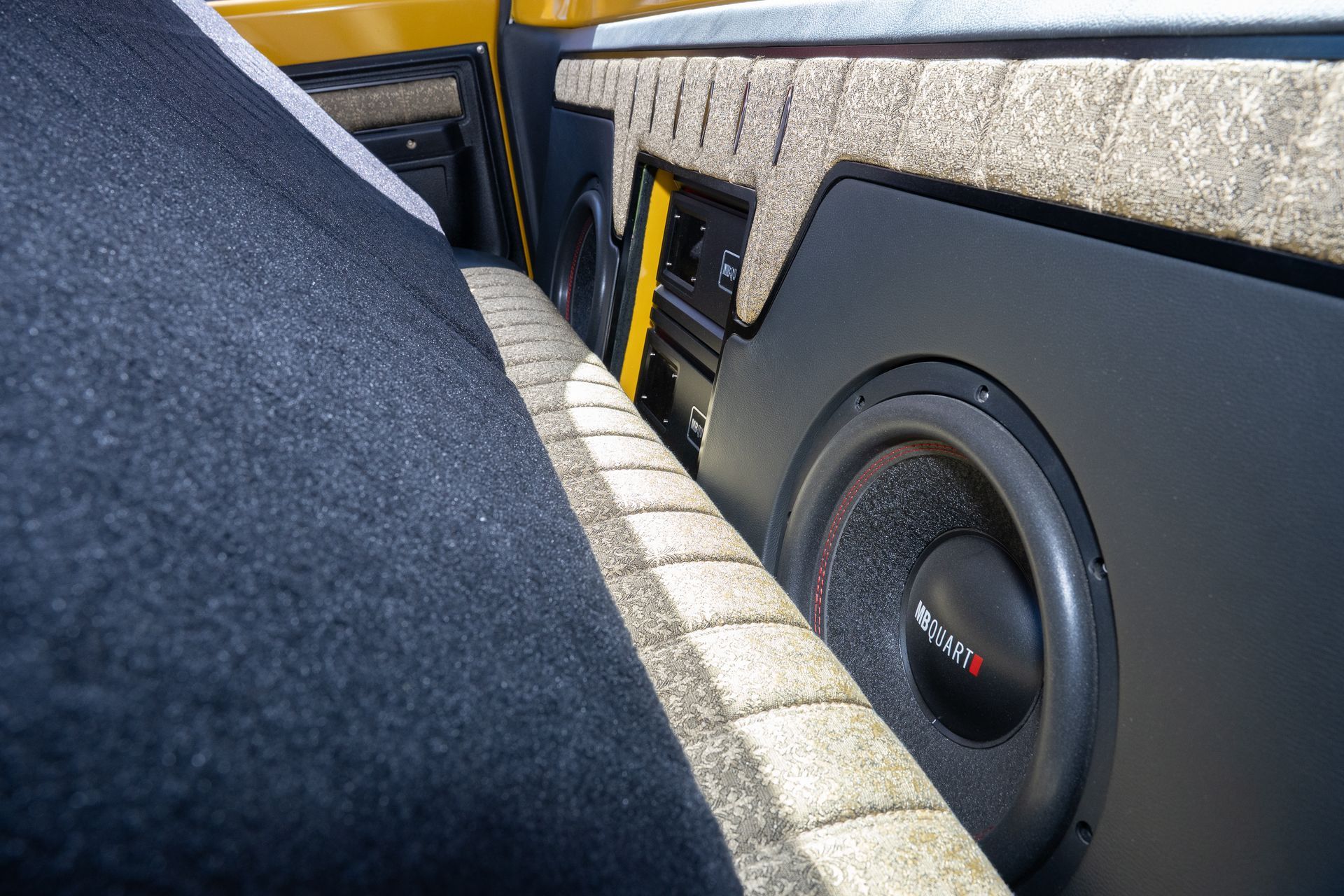 Car audio system: Subwoofer, amplifier, and head unit mounted in a custom panel.