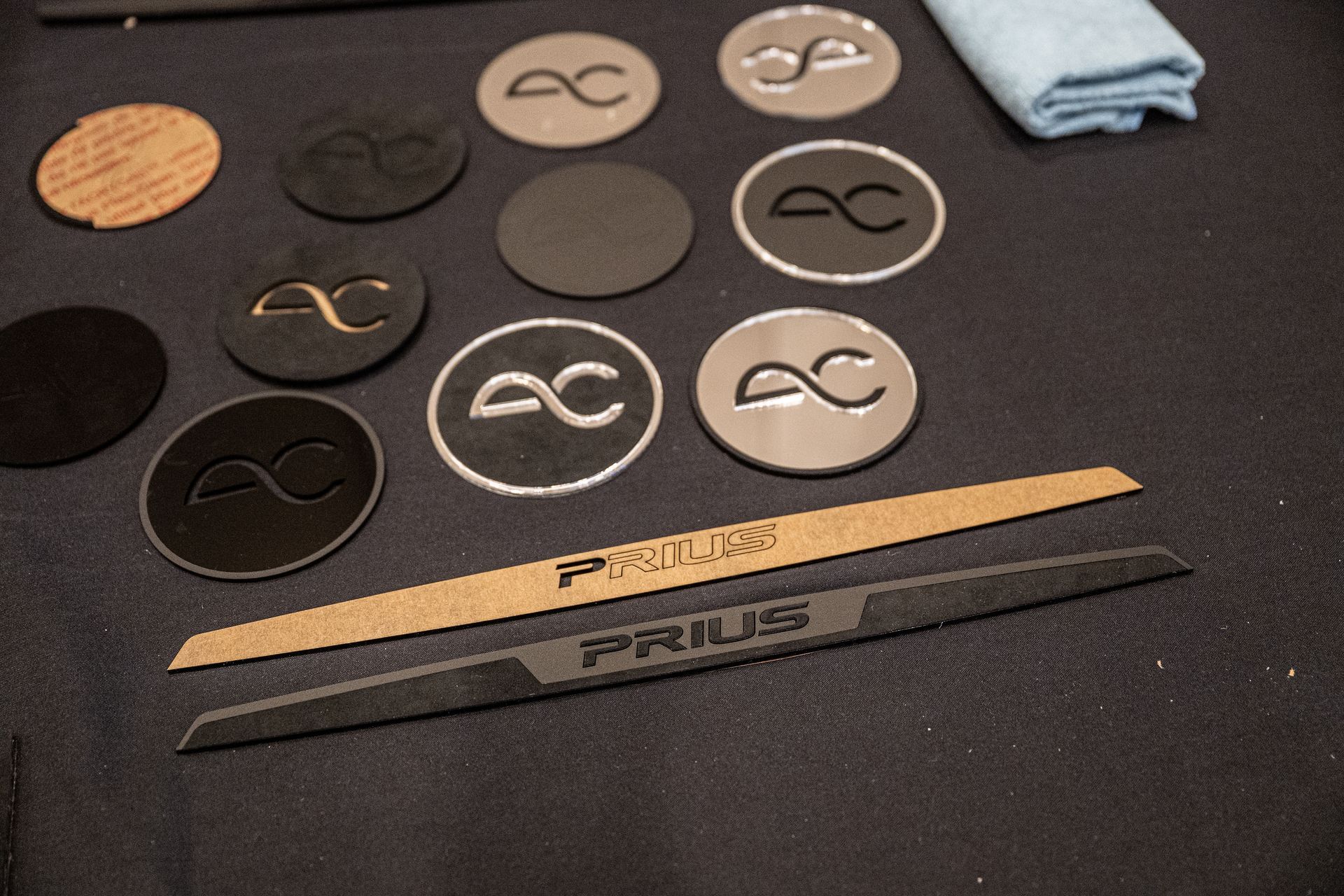 Various circular and rectangular car accessory pieces with logos and text.