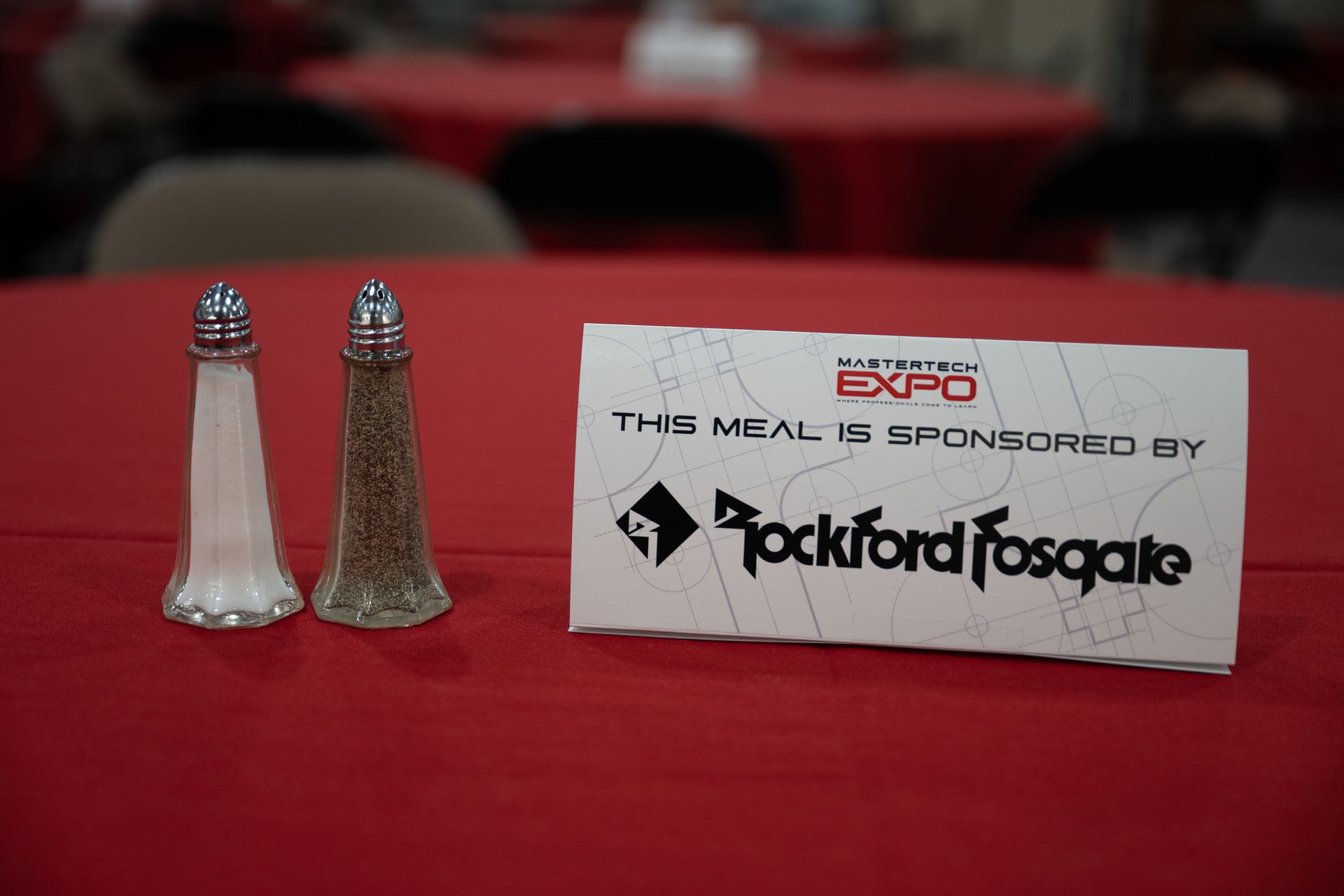 Salt and pepper shakers next to a sign that reads 