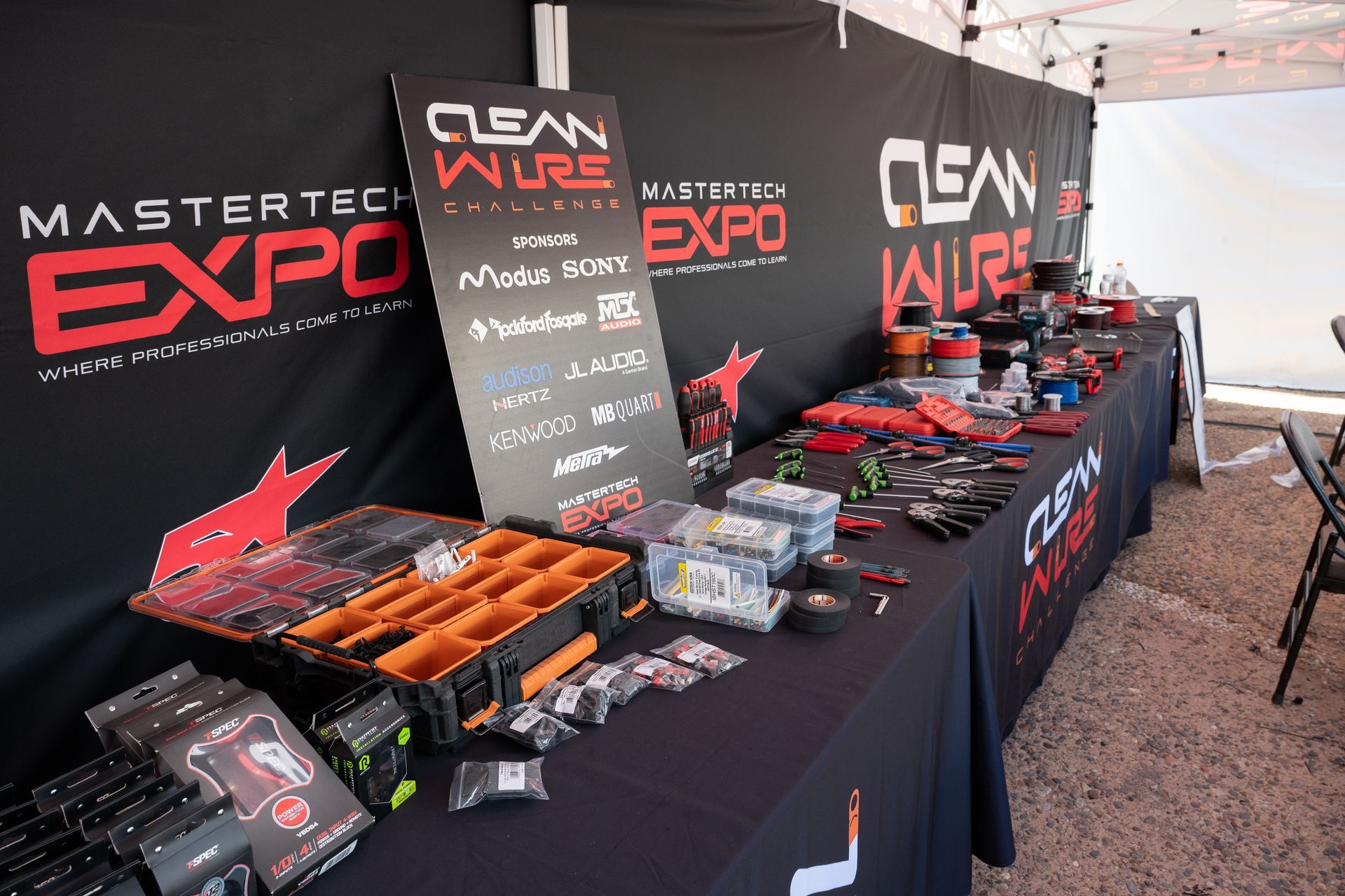 Table display at MasterTech Expo, with tools, products, and a Clean Wire banner.