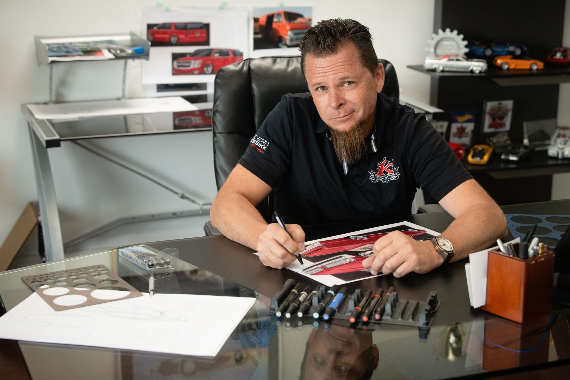 A man is sitting at a desk writing on a piece of paper