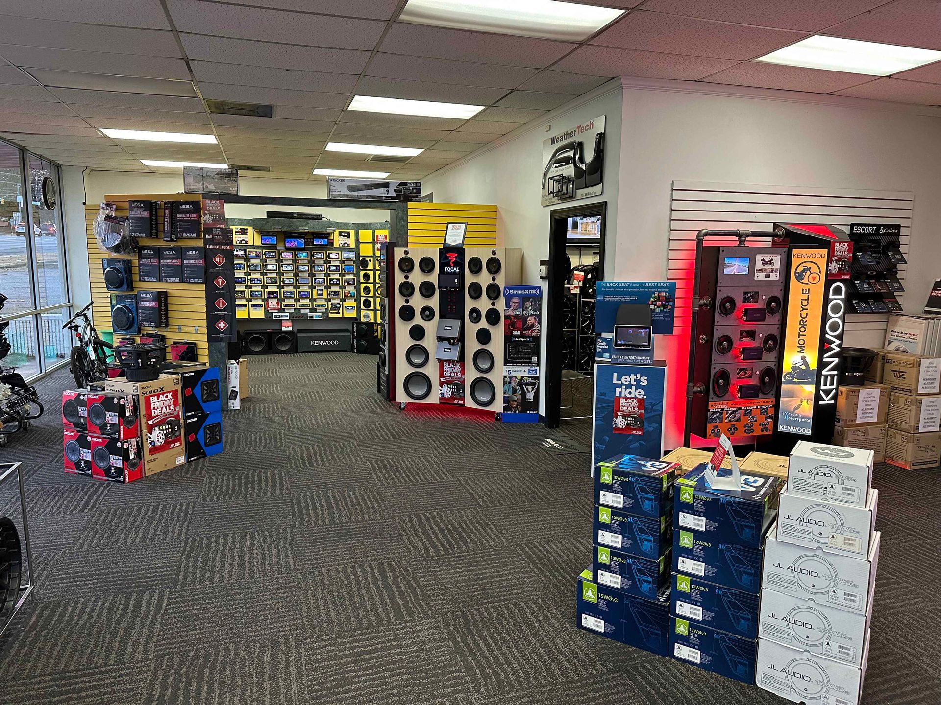 A large room filled with lots of speakers and boxes.