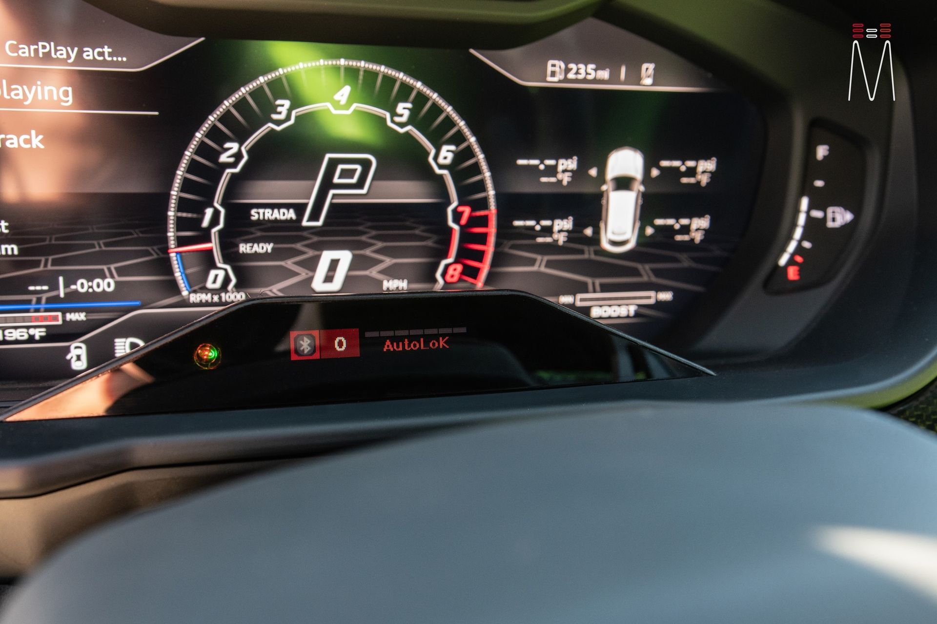 A close up of a car dashboard with a speedometer and a tachometer