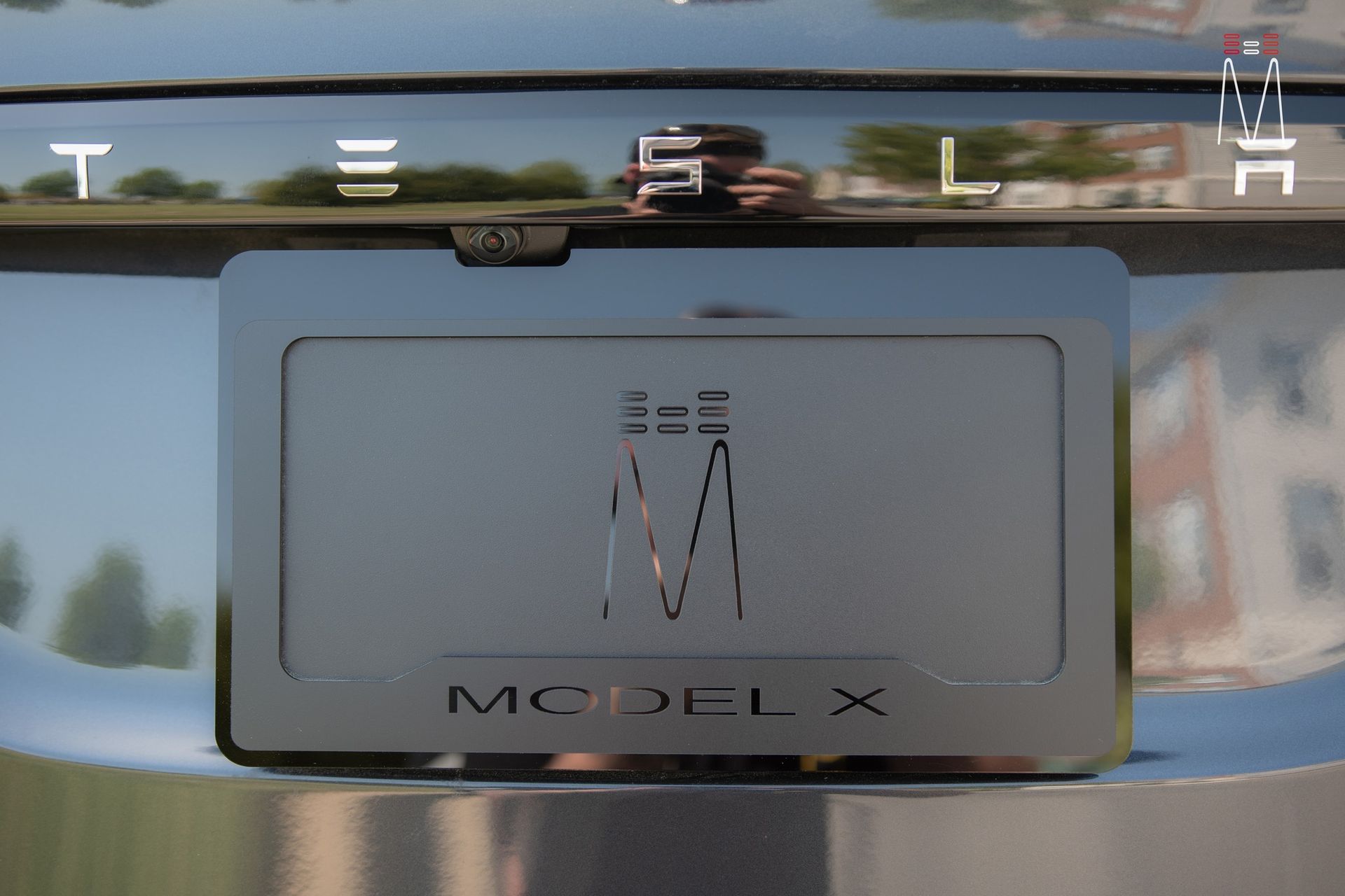 A close up of a tesla model x license plate