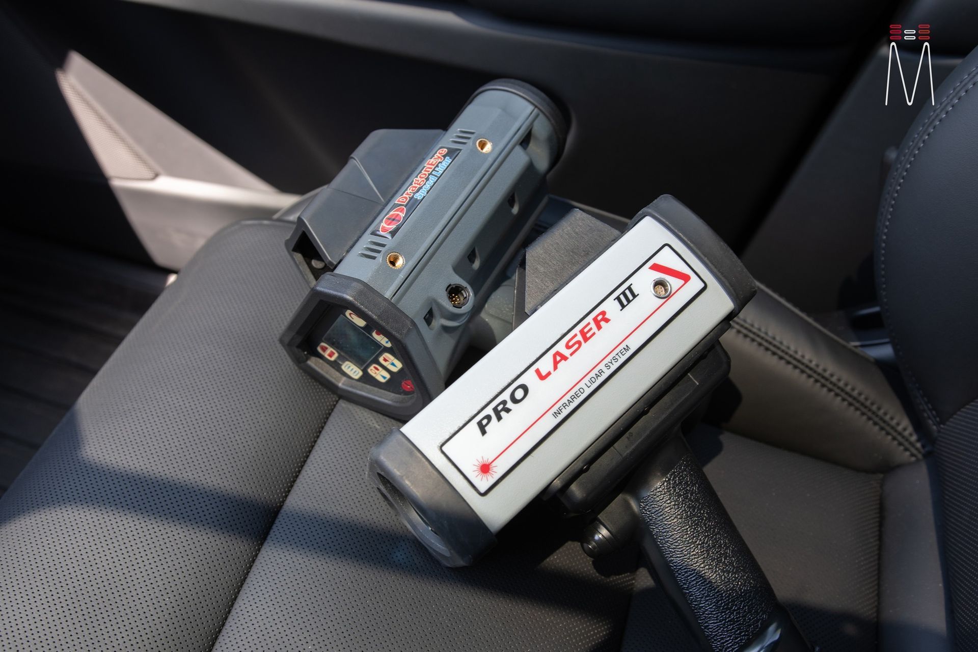 A pro laser device is sitting on a car seat