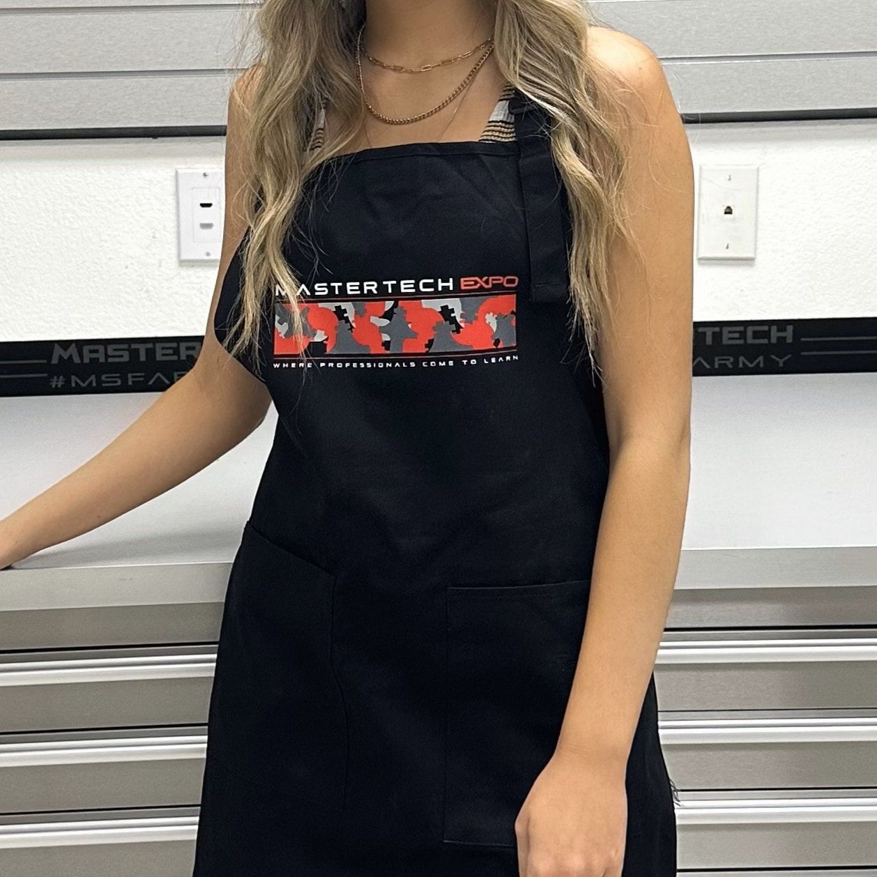 A woman wearing a black apron that says army on it