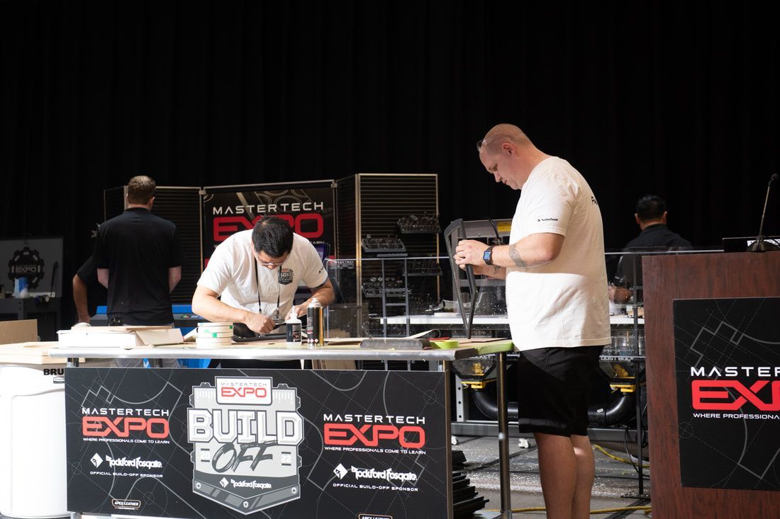 Two men are working on a project at a build expo