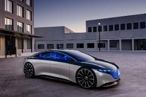 A mercedes benz eqs concept car is parked in front of a building.