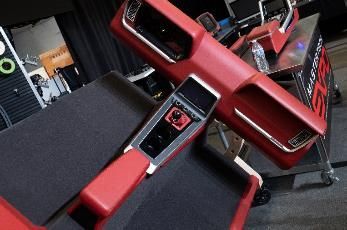 Red automotive interior components displayed on a table.