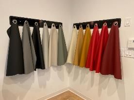 A room with a bunch of towels hanging on a wall.