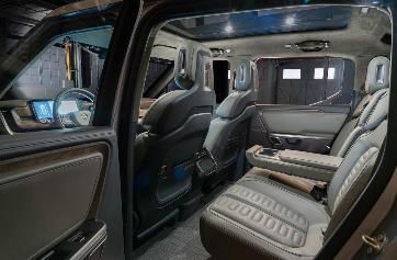 The interior of a car with a lot of seats and a sunroof.