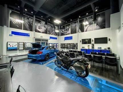 A car and a motorcycle are parked in a garage.