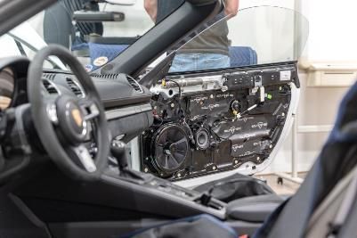 A man is working on the interior of a car.